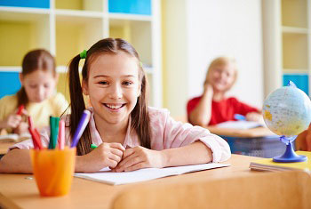 Girl student sit at the classroom desk, photo