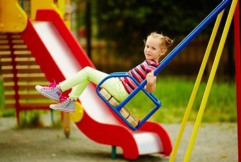 Girl swinging at the playground, photo
